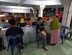 Polsek Binjai Kota Genjot Pencapaian Herd immunity Di Lapangan Tribun Lapangan Merdeka Malam Hari
